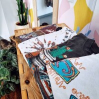 Im Laden Vintagesafari liegen T-Shirts auf einem Sideboard